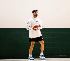Justin Razooky teaching ball handling techniques to young basketball player with the help of basketball training software